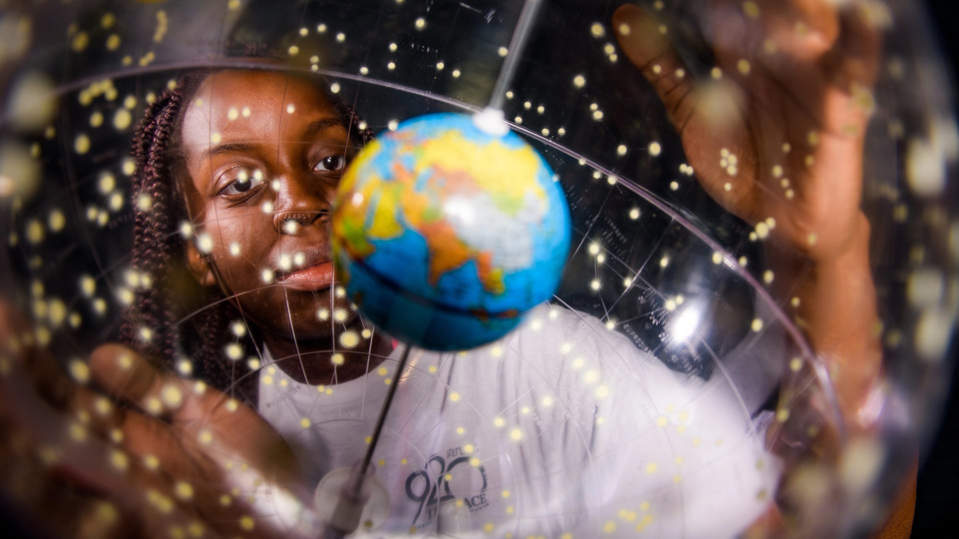 Image of a person looking at a globe