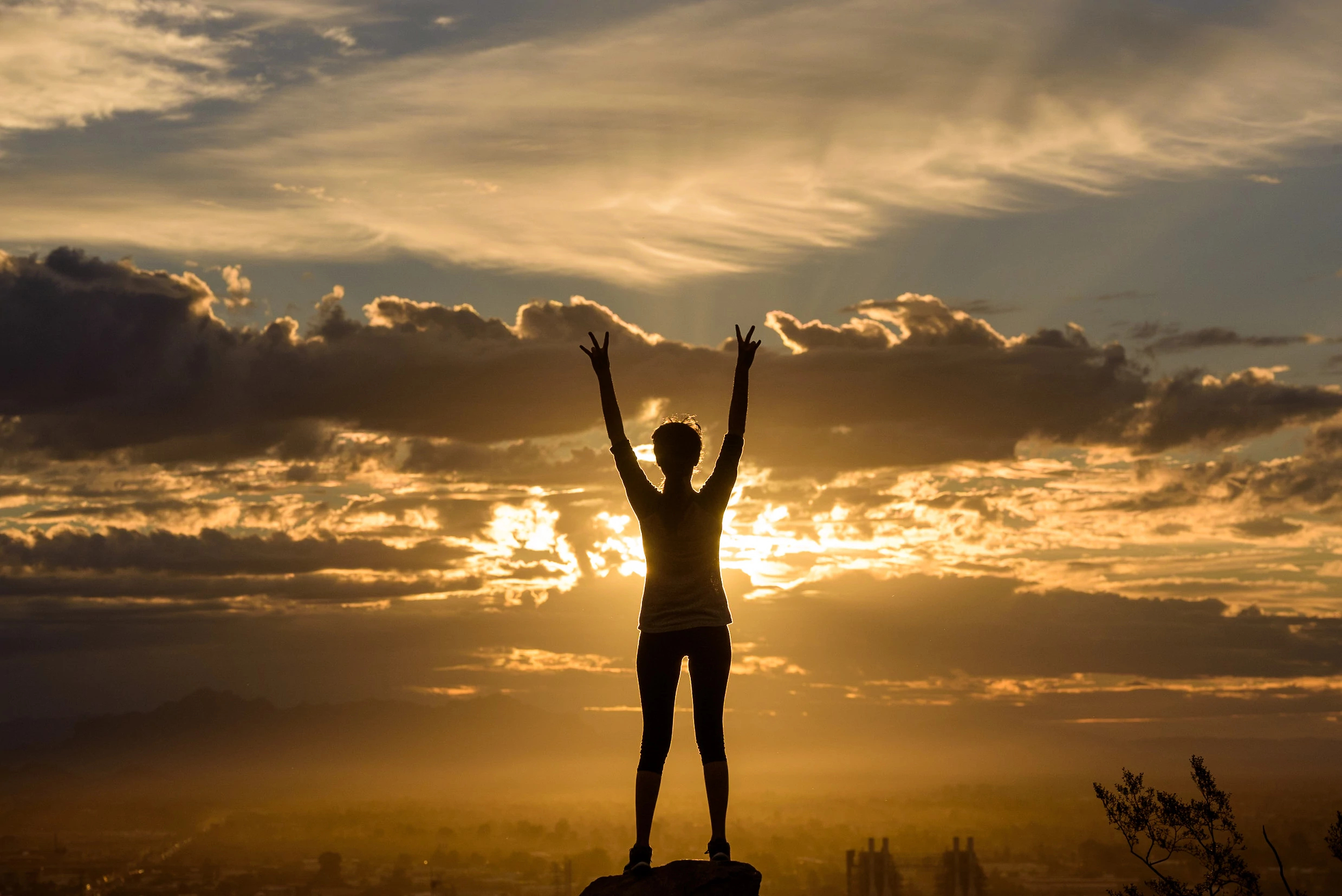 Image of a person's silhouette in front of clouds