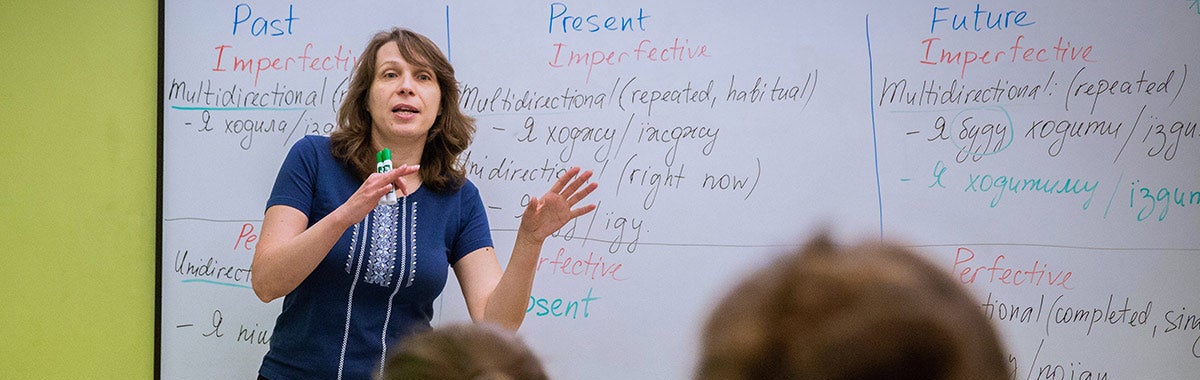 Image of an educator speaking in front of a white board