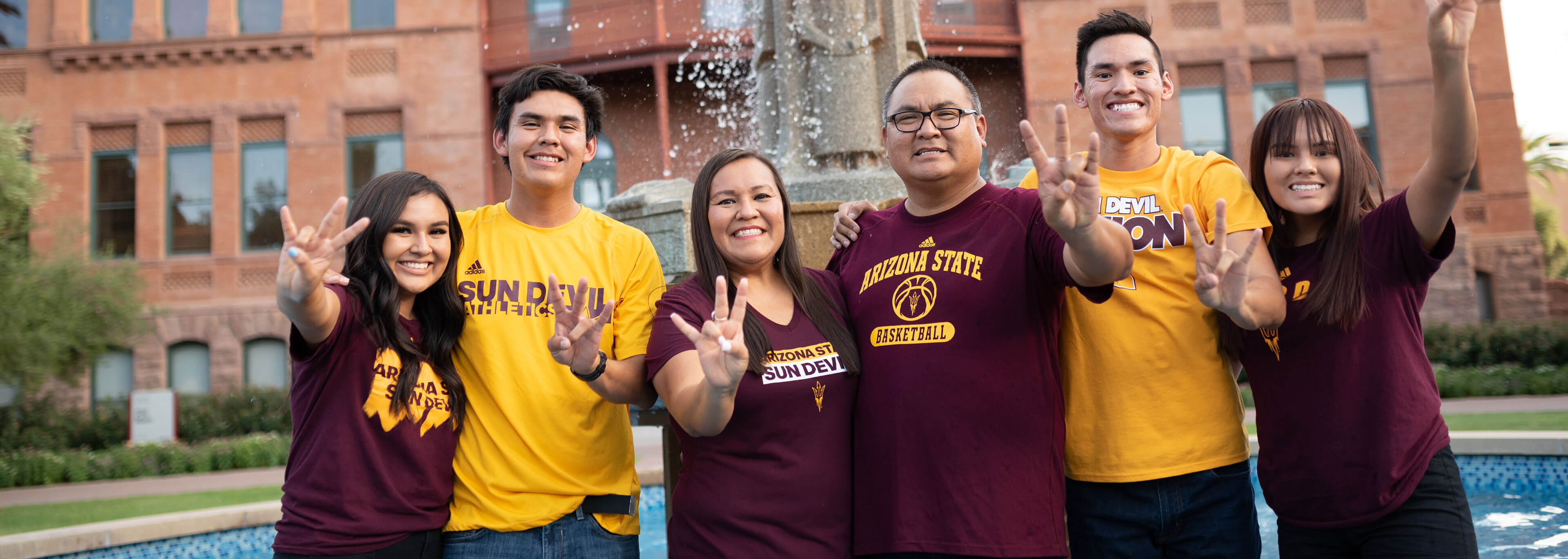 ASU students with family near old main building