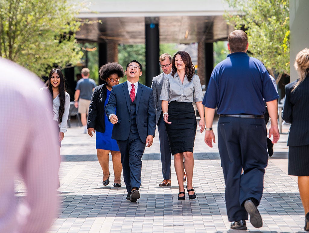 business people walking through campus
