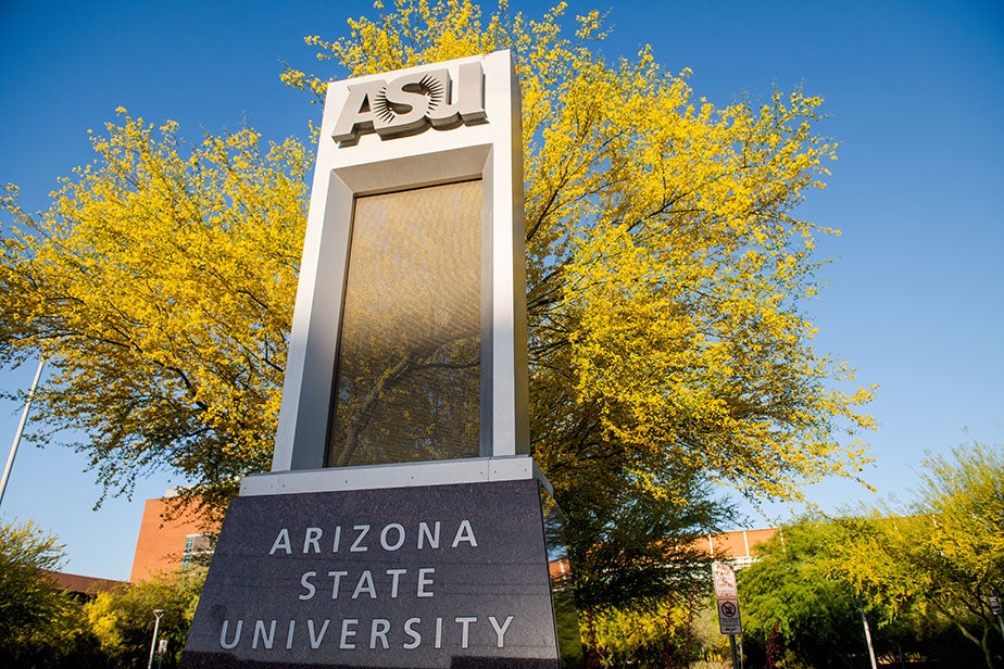 ASU sign on campus with gold leaves and blue sky in the background