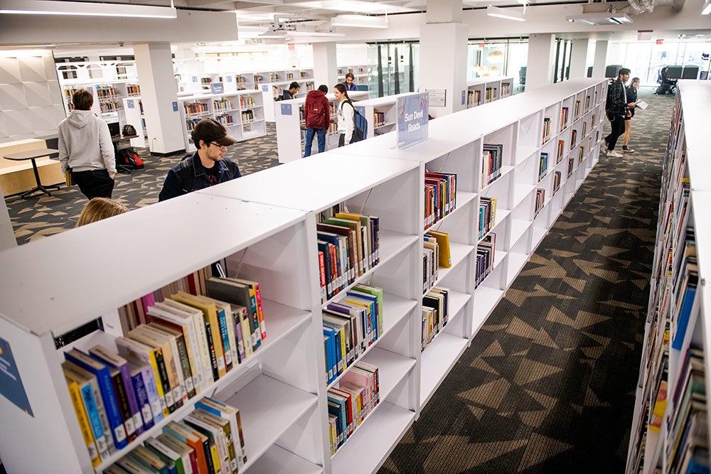 Students browsing books in Hayden Library