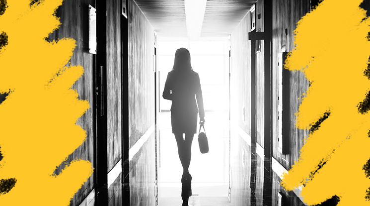 A silhouette of someone walking down a hallway.