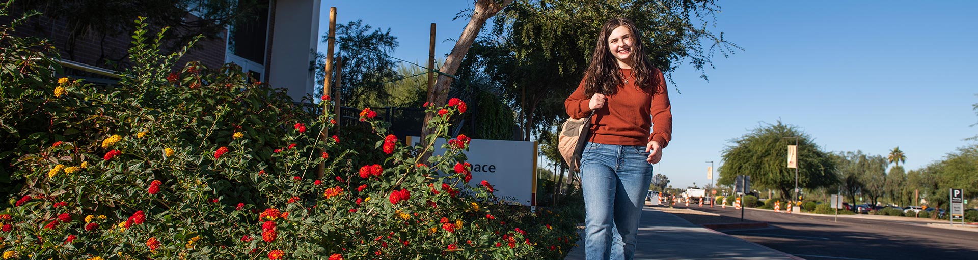 Student walking on the ASU West Valley campus