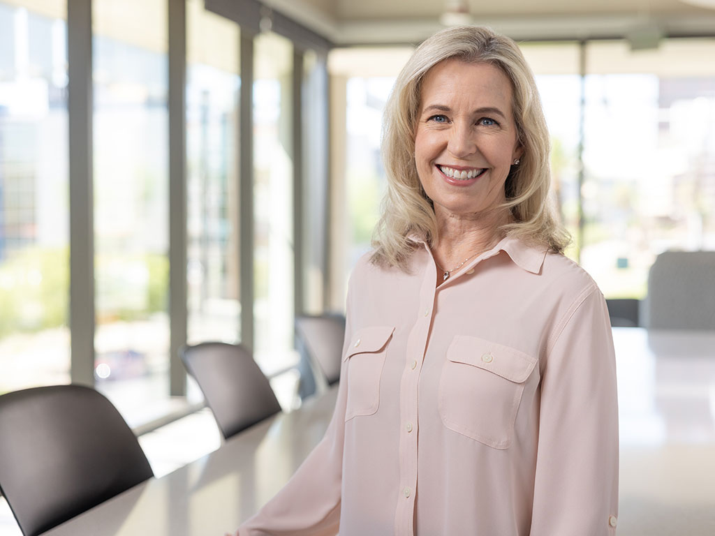 Alum in a brightly lit boardroom