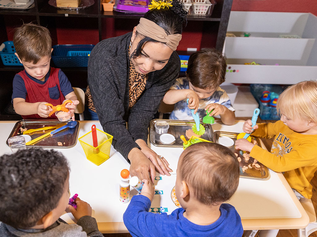 teacher working with preschool students