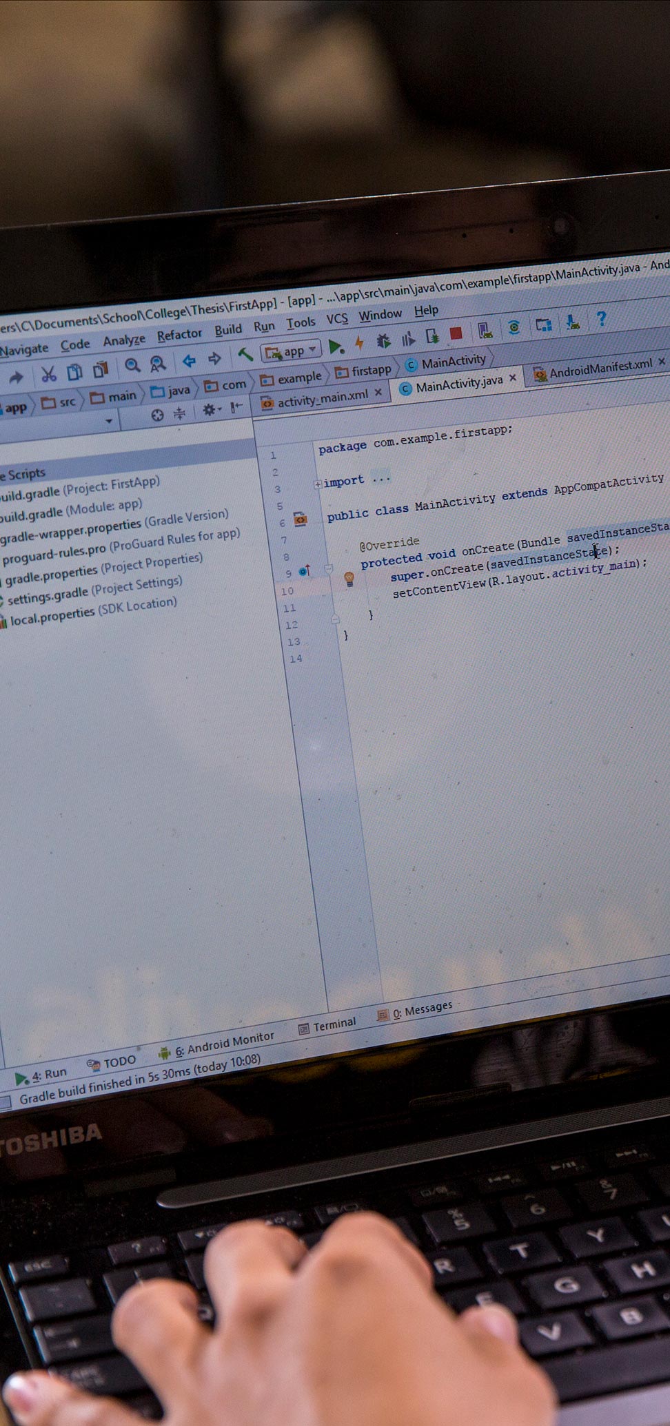 person editing code on a laptop