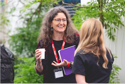 Image of Cathy Cullicott speaking with someone else
