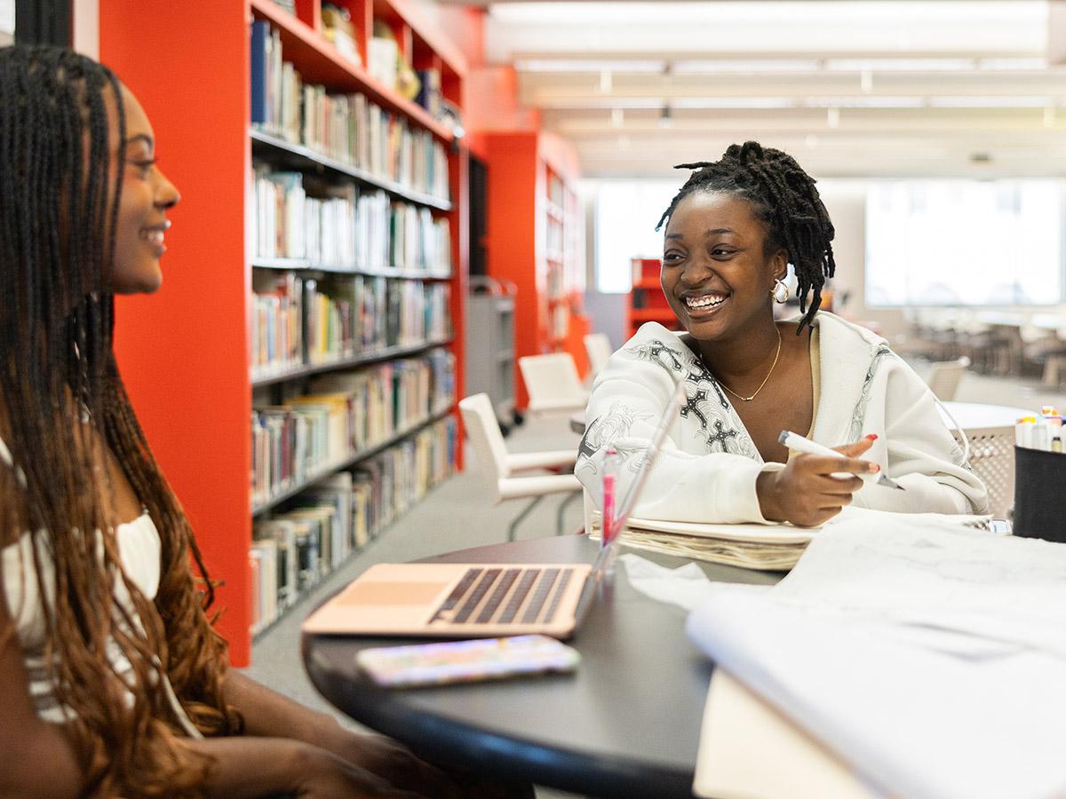 woman working on a project in the library